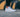 White Nike Sneakers infront of a black and orange wall