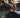 Man doing push ups in the background of a bag with a couple of SmellWell inserts and a bottle in it