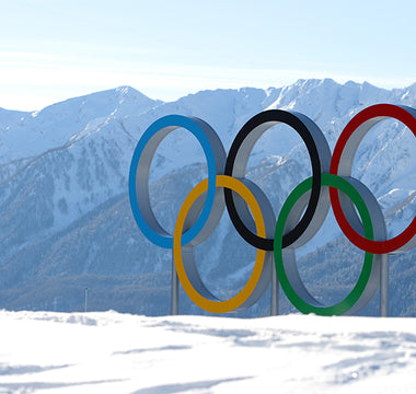 The Olympic Rings standing up on a snow-covered mountain