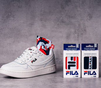 White FILA sneaker with SmellWell Active insert and two packages of SmellWell & FILA Collab Inserts
