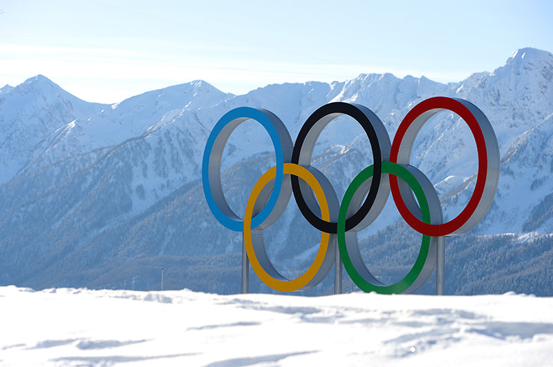 The Olympic Rings standing up on a snow-covered mountain