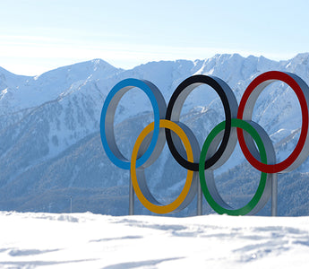 The Olympic Rings standing up on a snow-covered mountain