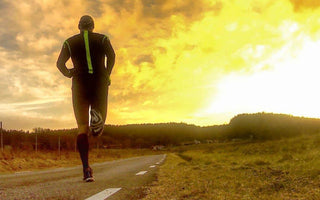 Man running on a road into the sunset