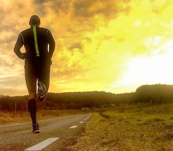 Man running on a road into the sunset