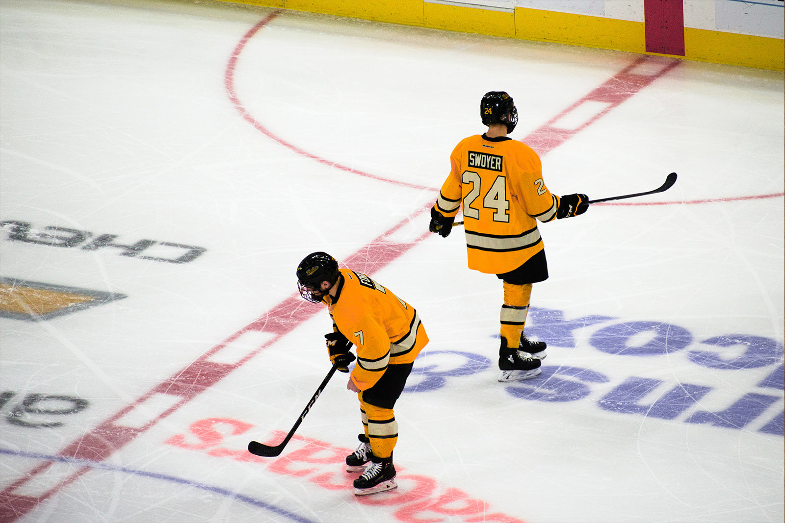 Two kids on the ice in their hockeygear during a hockeygame