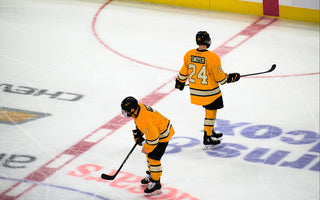Two kids on the ice in their hockeygear during a hockeygame