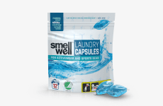 A package of SmellWell Laundry Capsules and 2 laundry capsules